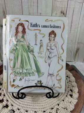 Faith's Cameo Fashions Paper Doll Set.Seven paper dolls with outfits.